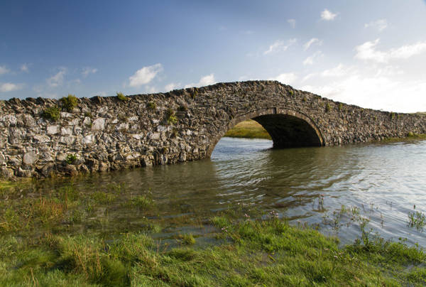 Pont Aberffraw a single span hump-backed built in 1731 and has a segmental arch with dressed stone. 