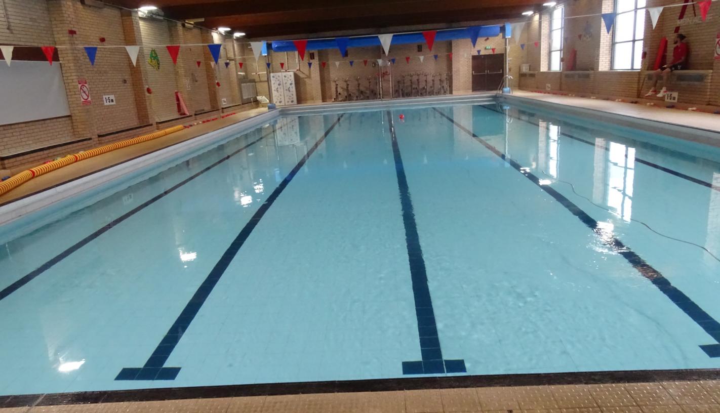 Swimming pool showing light blue clear water with 6 swimming lanes marked