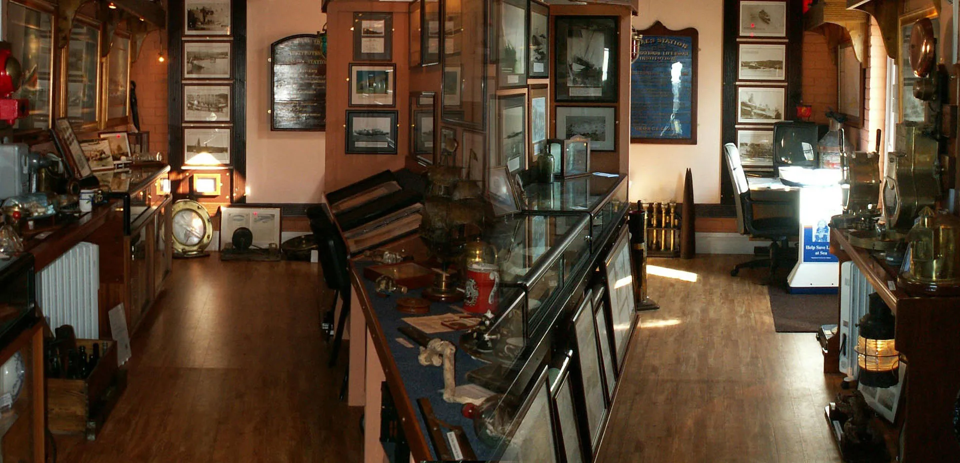 Cemaes Maritime Collection showing artefacts in glass cases and on the walls