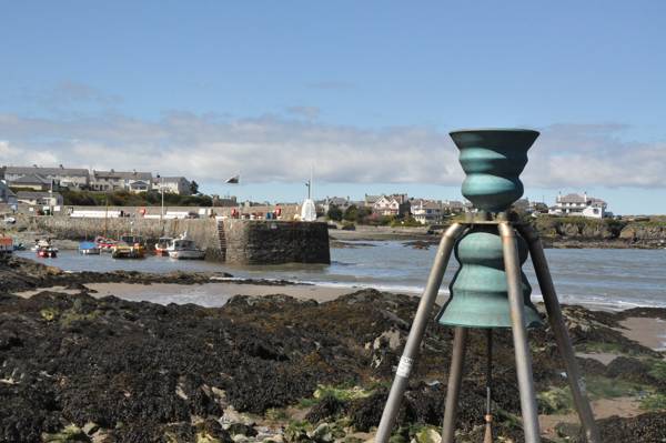 Cemaes tidal bell looking like an alien spaceship in the harbour