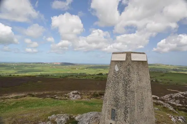 Trig point at the top of bodafon mountain looking towards Parys mountain and Irish sea