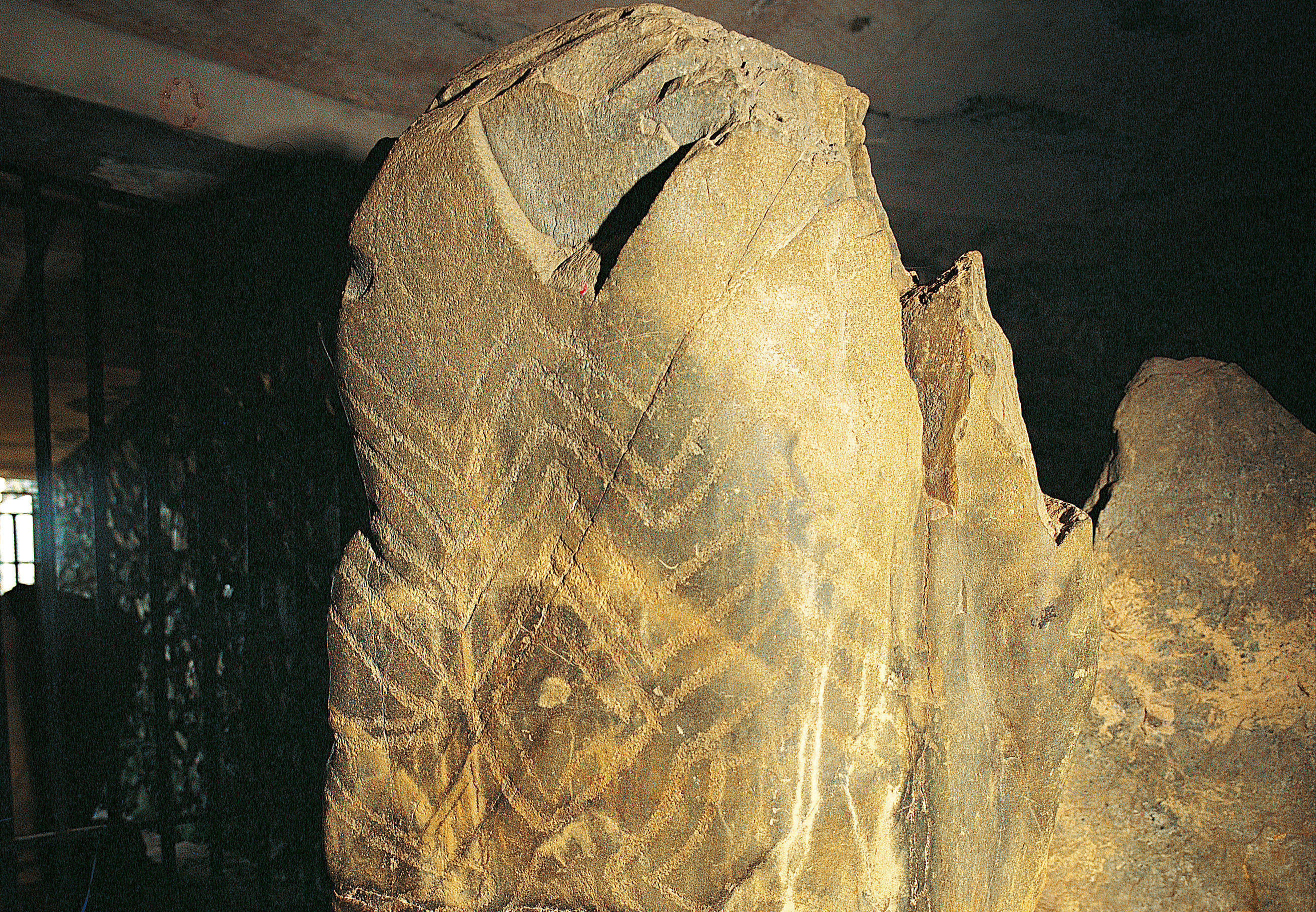One of five ancient etched stones within Barclodiad y Gawres showing ancient zig zag patterns 