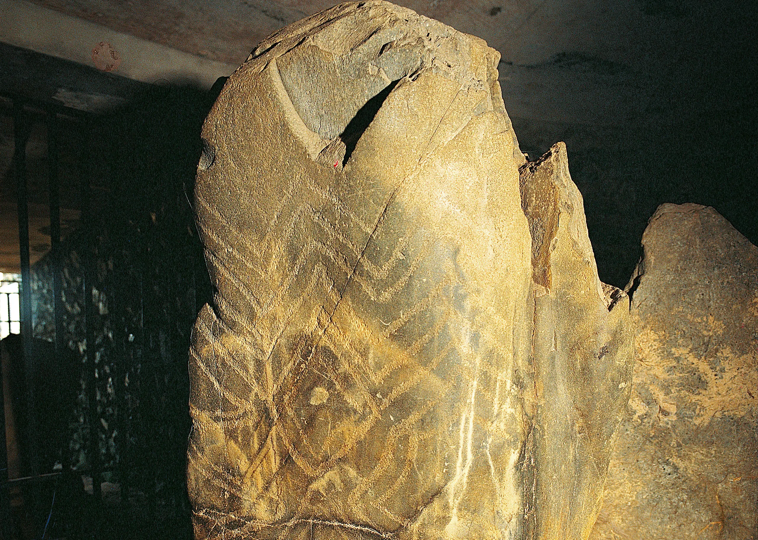 One of five ancient etched stones within Barclodiad y Gawres showing ancient zig zag patterns