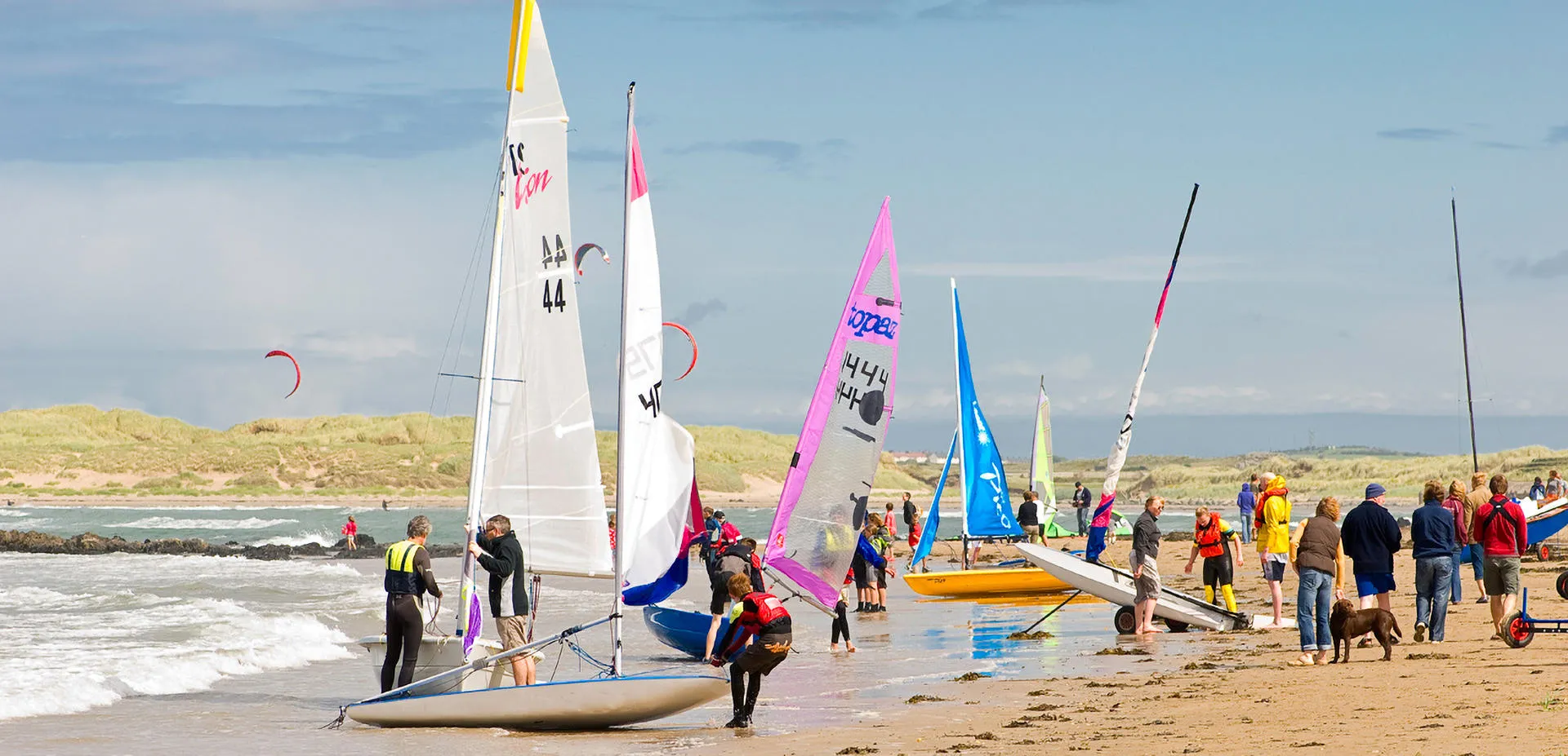 Group preparing to go sailing on the beach