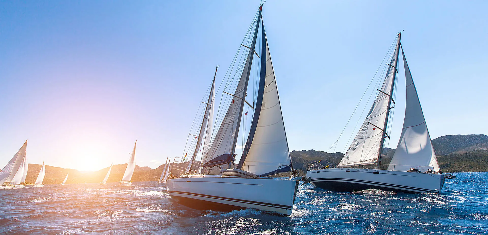 large Sailing yachts racing in full sail going upwind close hauled of Holyhead mountain