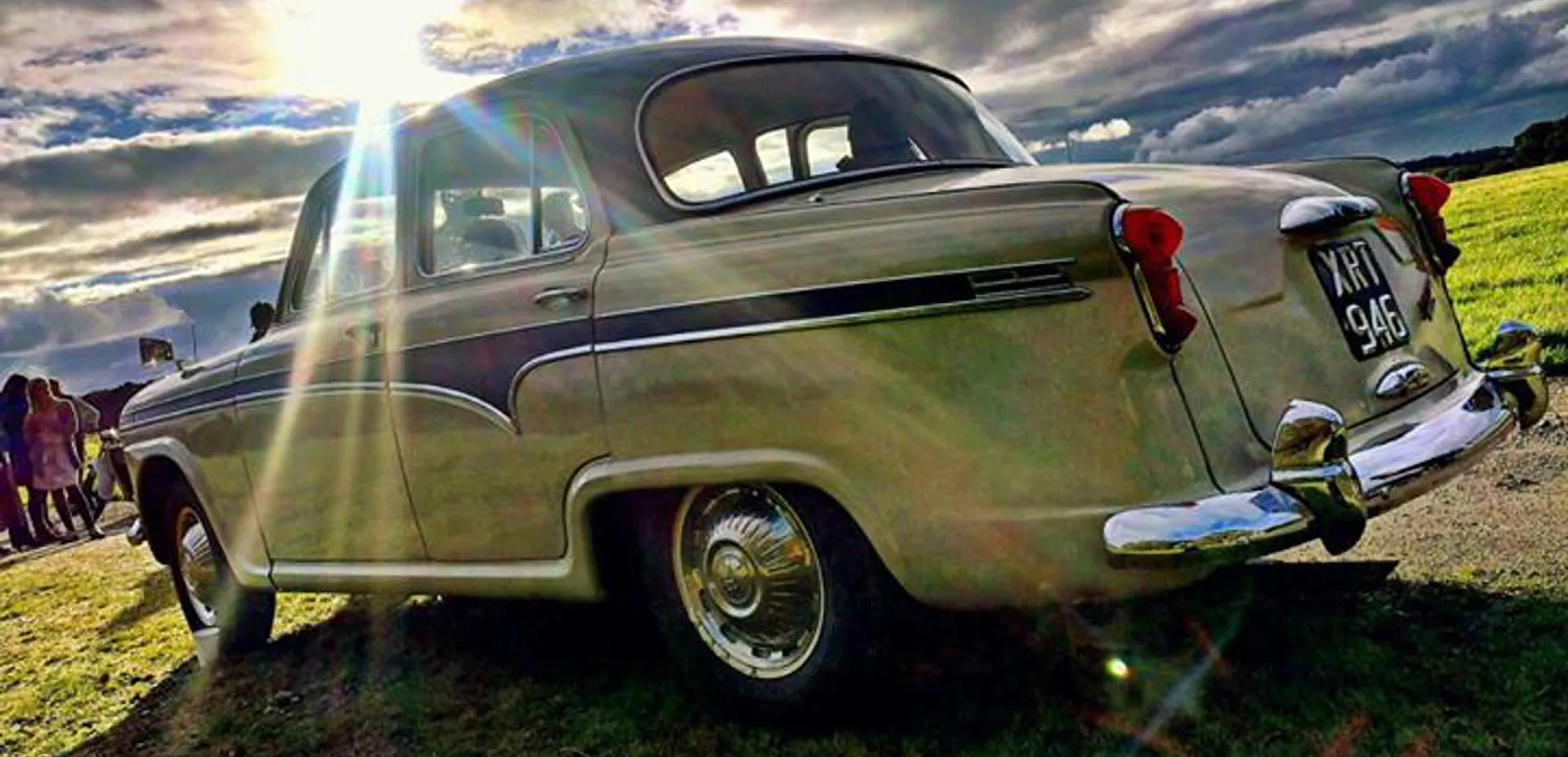 The sun beaming on a green vintage car