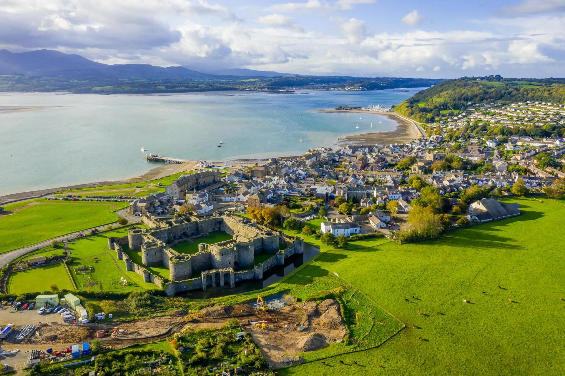 Aerial view looking down on Beaumaris Castle and high street with Menai strait behind