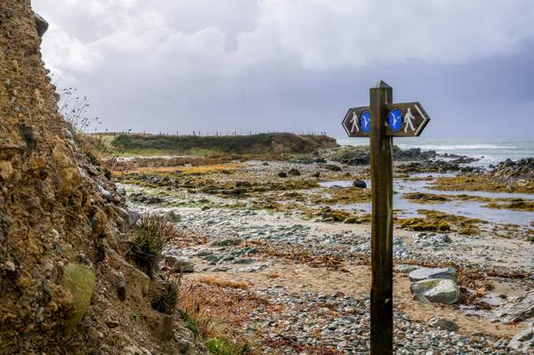 Coastal Path sign on a rocky shoreline