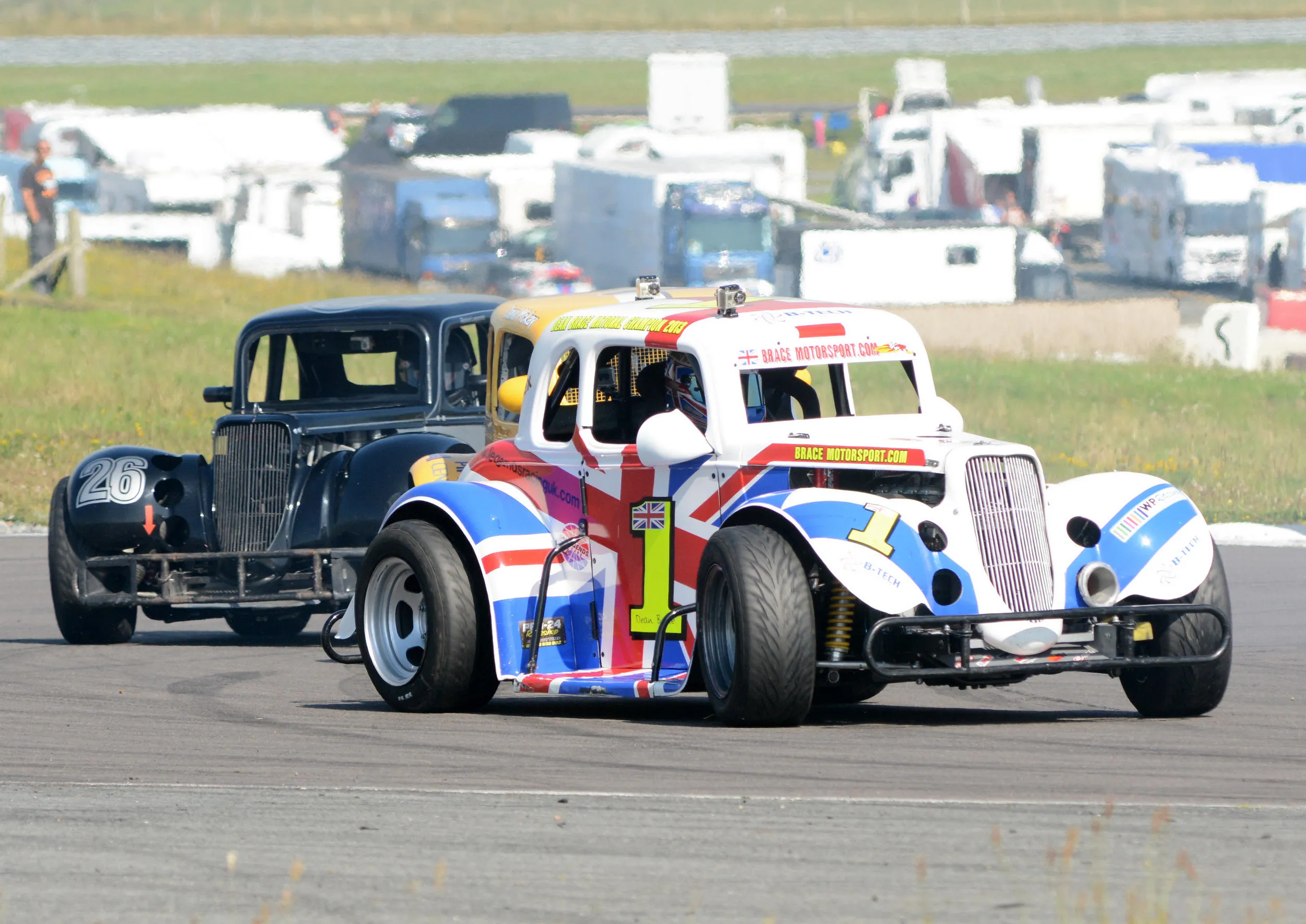 Race cars cornering at Anglesey Circuit