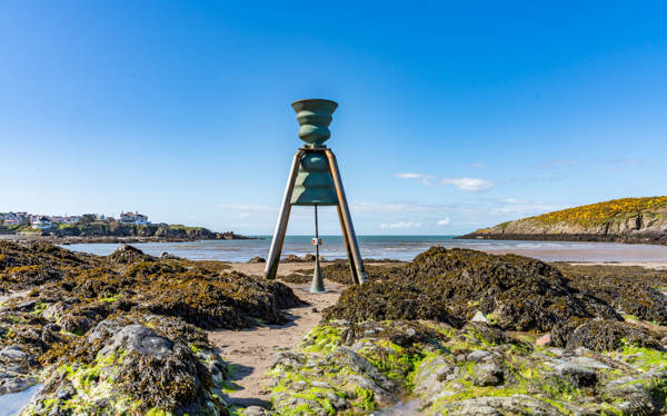 Cemaes tidal bell at low tide like an alien on the beach