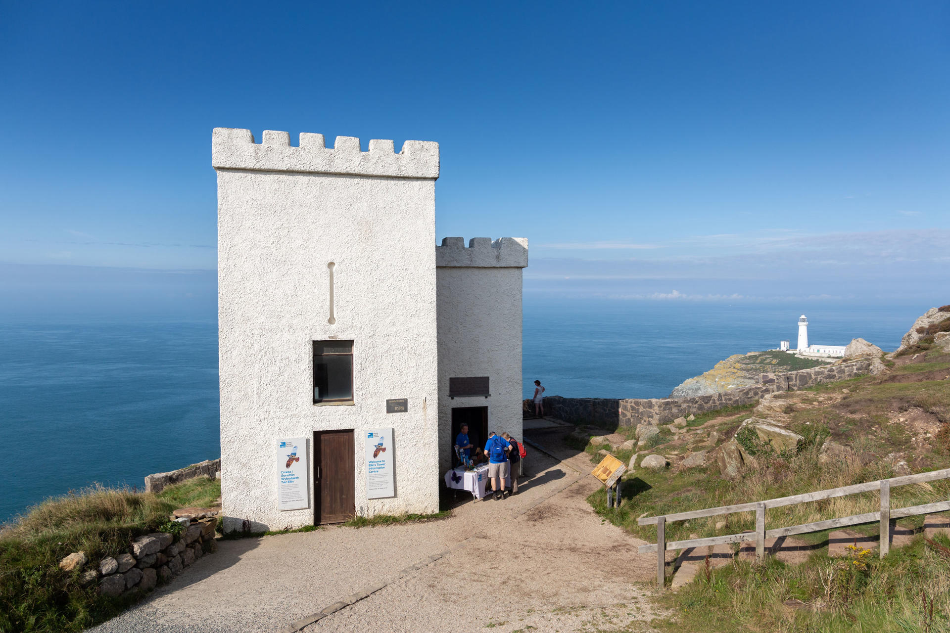 Exterior view of Elin's tower overlooking the sea with South Stack and lighthouse in the distance
