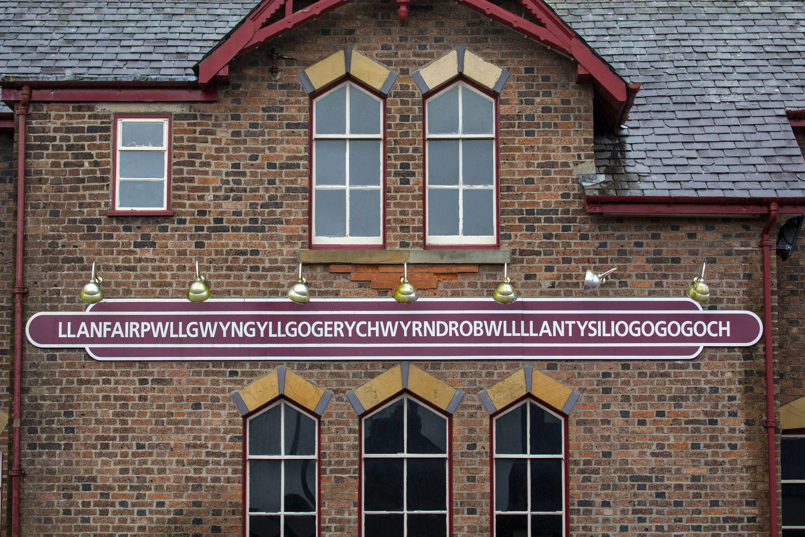 Long sign of the village name on the station building