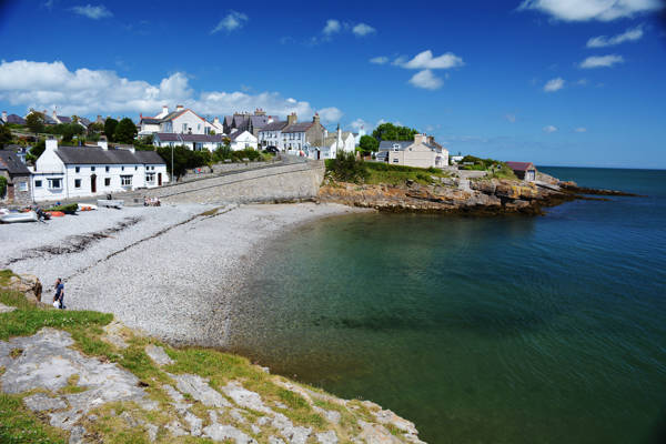 The bay at Moelfre surrounded by houses on the cliffs