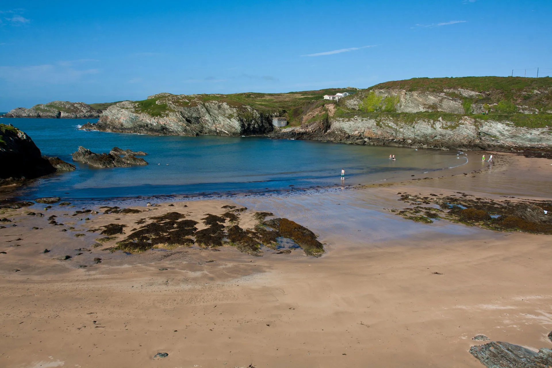 Porthdafarch beach at low tide on a sunny day
